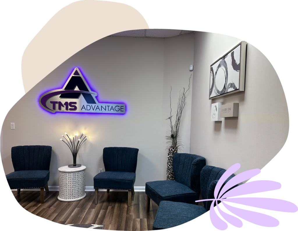 A photo of the Advantage TMS office waiting room. It is comfortable and calm, with dark blue chairs and neutral-colored decor.