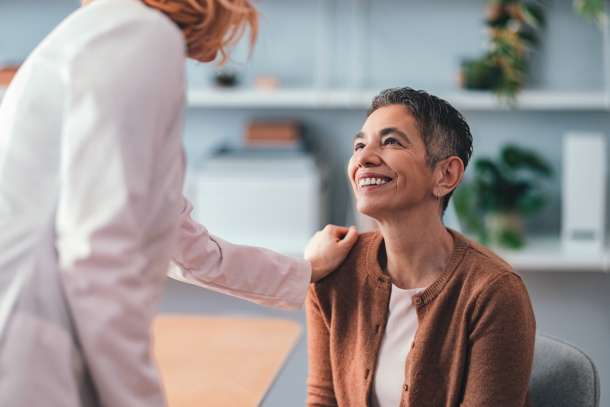 A provider smiling with a patient